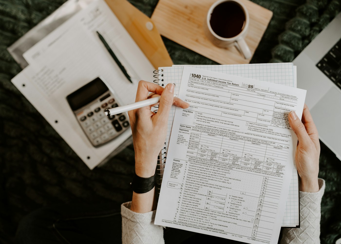 Advisor reviewing payroll documents on a laptop