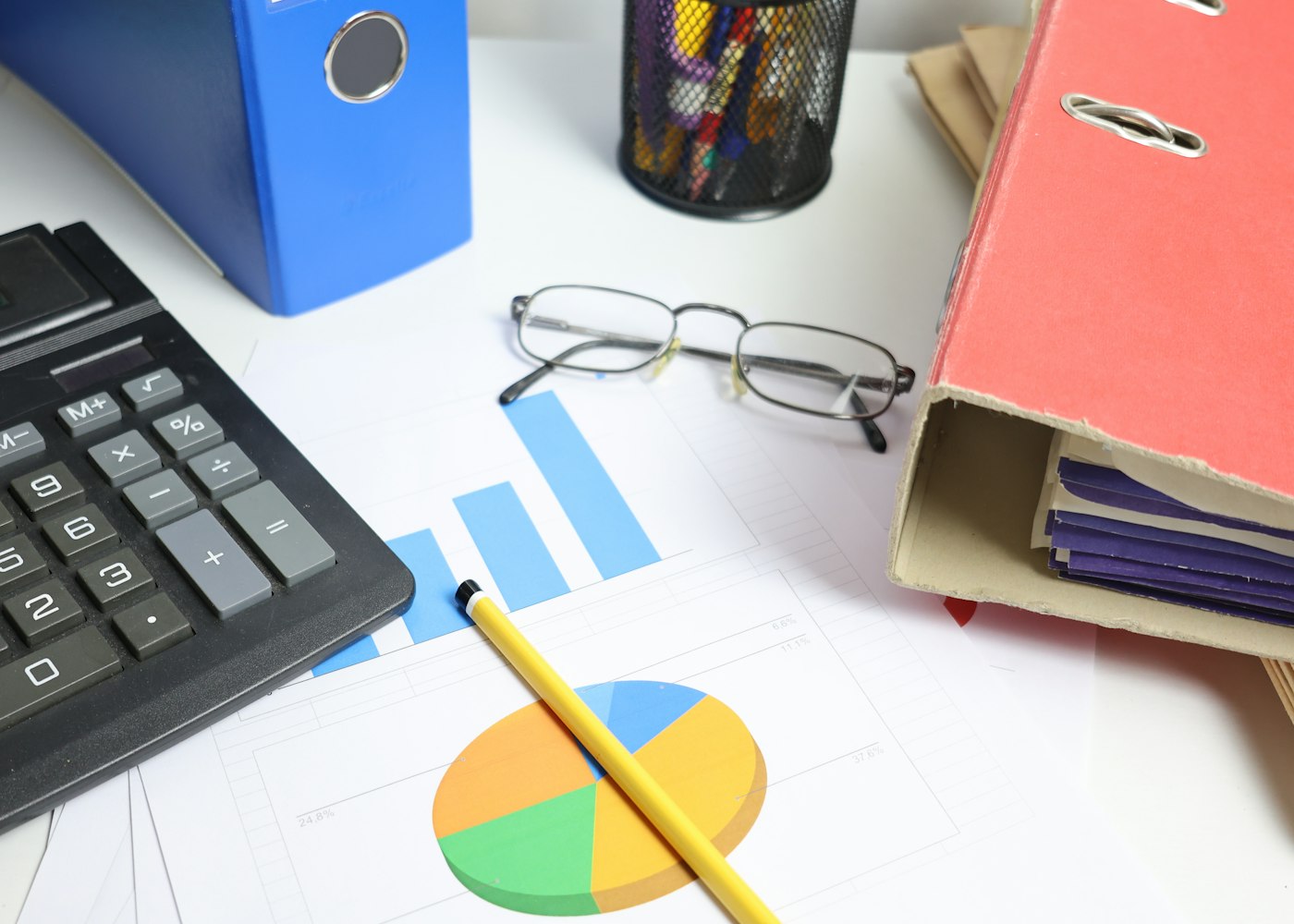 Charts, binders and calculator showing management accounts